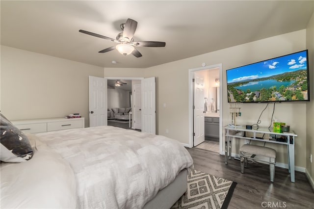 bedroom with ceiling fan, ensuite bathroom, and dark wood-type flooring