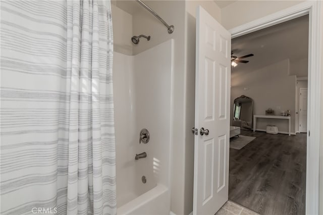 bathroom with ceiling fan, hardwood / wood-style floors, and shower / bath combo