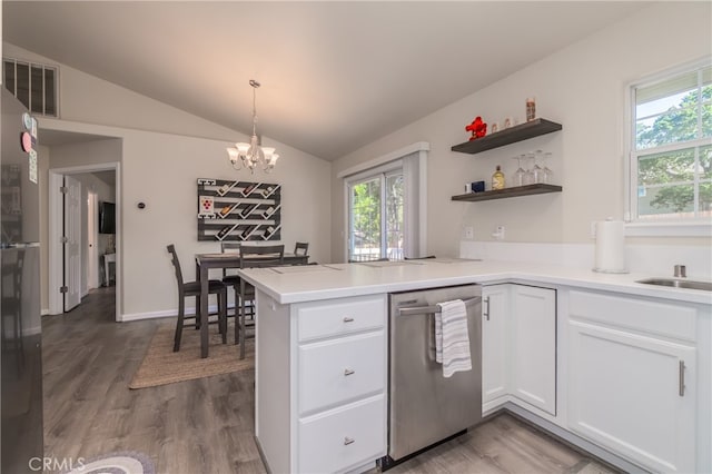 kitchen with lofted ceiling, kitchen peninsula, white cabinetry, and dishwasher