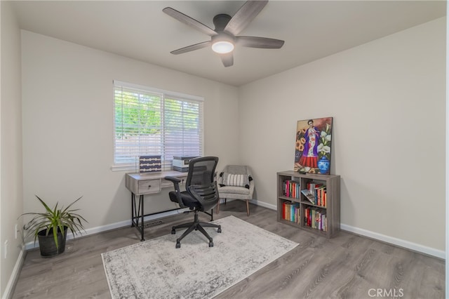 office area with ceiling fan and hardwood / wood-style floors