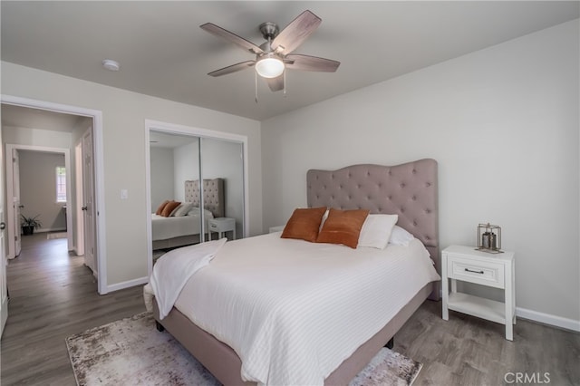 bedroom with hardwood / wood-style floors, a closet, and ceiling fan