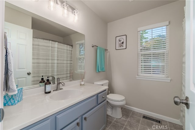 bathroom featuring tile patterned flooring, vanity, and toilet