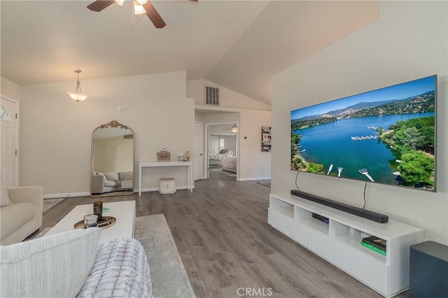 living room with ceiling fan, hardwood / wood-style flooring, and lofted ceiling