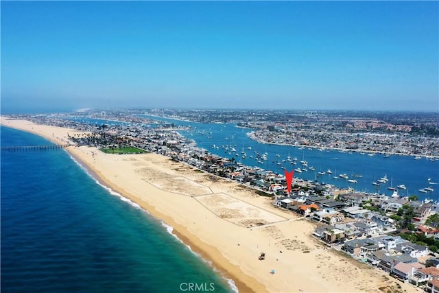 birds eye view of property featuring a water view and a beach view