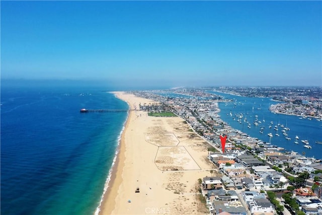 birds eye view of property featuring a water view and a beach view