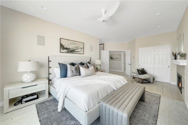 bedroom with light carpet, a closet, and ceiling fan