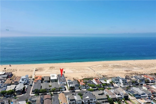 birds eye view of property featuring a water view and a beach view