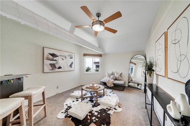 carpeted living area featuring lofted ceiling and a ceiling fan