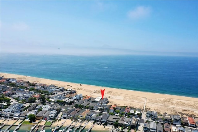 birds eye view of property with a water view and a view of the beach