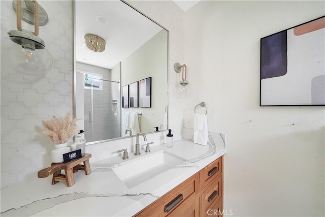 bathroom featuring a tile shower and vanity