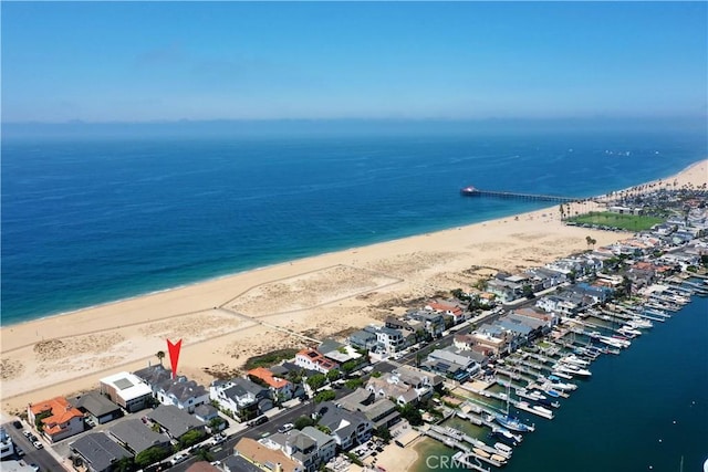 drone / aerial view with a water view and a beach view