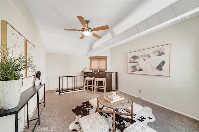 living area with ceiling fan, carpet, and lofted ceiling