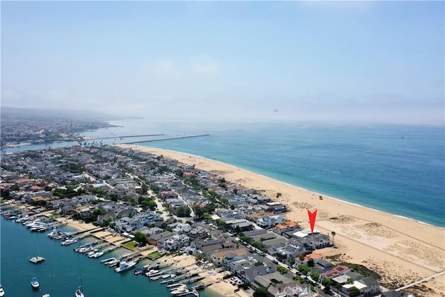 drone / aerial view with a water view and a beach view