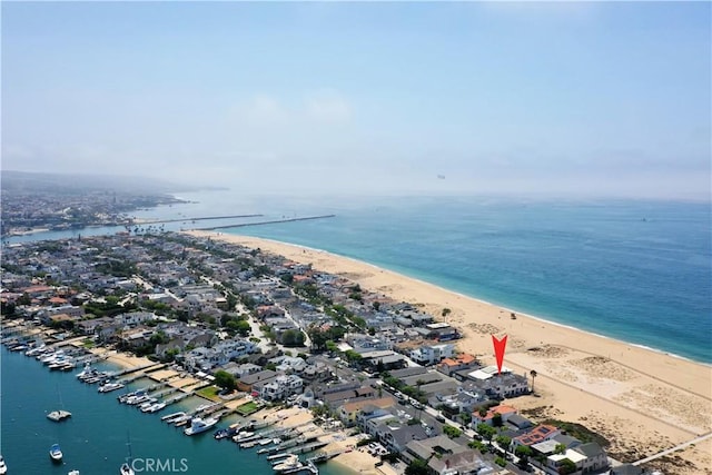 birds eye view of property with a beach view and a water view