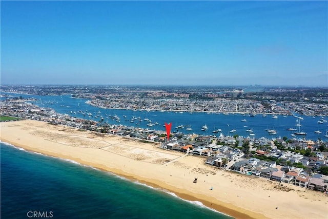 birds eye view of property featuring a water view and a view of the beach