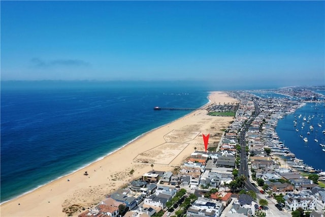 drone / aerial view featuring a beach view and a water view