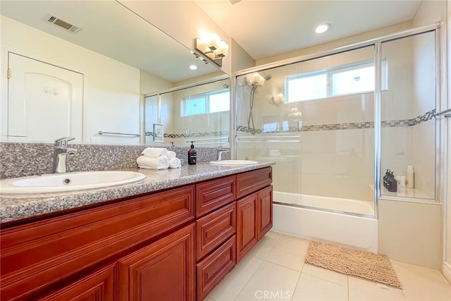 bathroom featuring tile patterned floors, vanity, and shower / bath combination with glass door