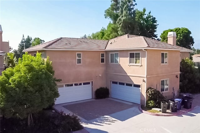 back of property with a garage