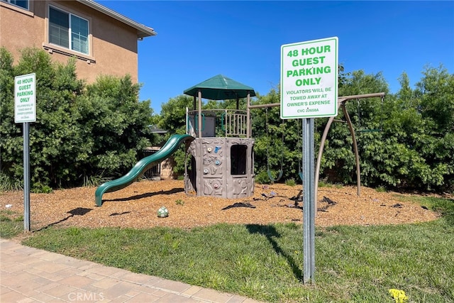 view of playground with a lawn