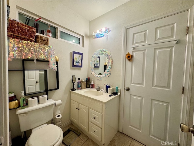 bathroom with tile patterned floors, vanity, and toilet