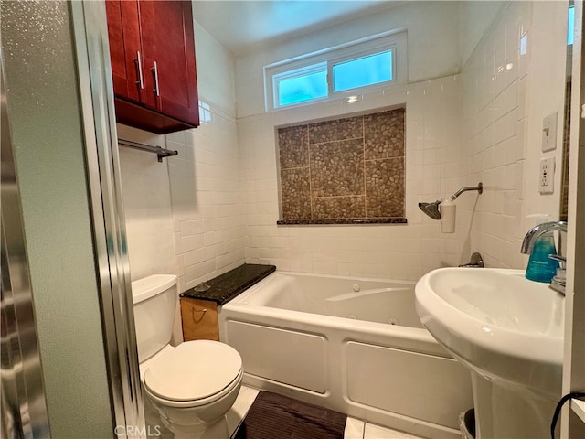 bathroom featuring a tub to relax in, tile walls, and toilet