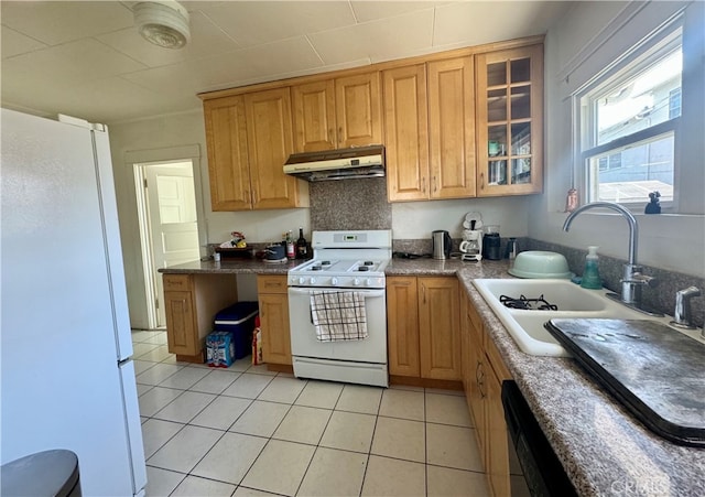 kitchen with light tile patterned floors, sink, and white appliances