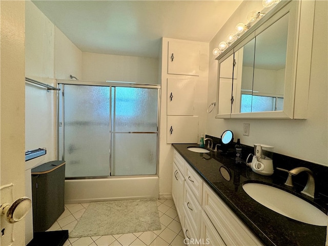 bathroom with shower / bath combination with glass door, tile patterned flooring, vanity, and a wealth of natural light