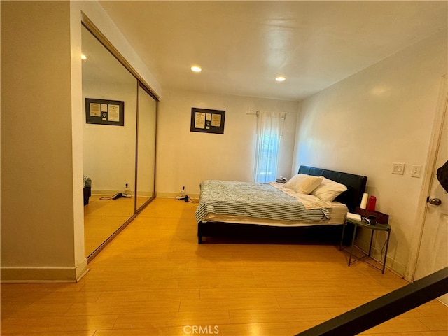 bedroom featuring light hardwood / wood-style flooring and a closet