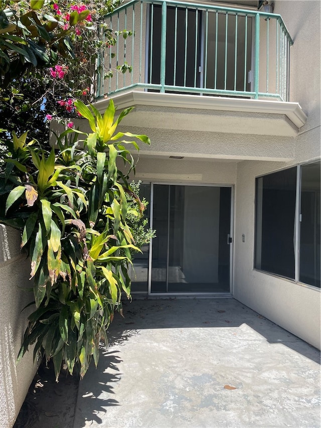 entrance to property with a balcony and a patio area