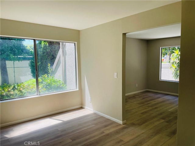 unfurnished room with hardwood / wood-style floors