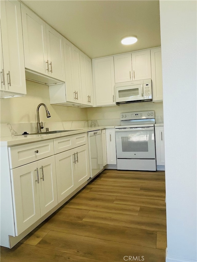 kitchen featuring white appliances, dark hardwood / wood-style flooring, sink, and white cabinets