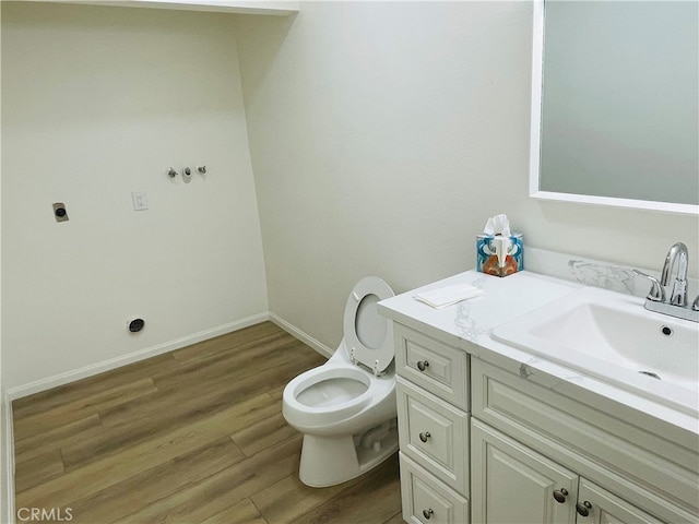 bathroom with vanity, toilet, and hardwood / wood-style flooring