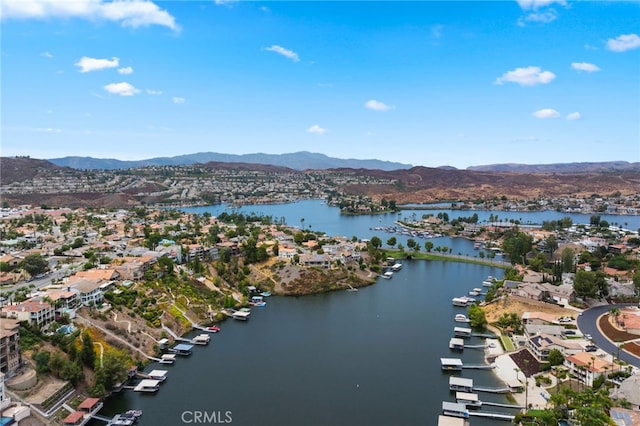 birds eye view of property with a water and mountain view