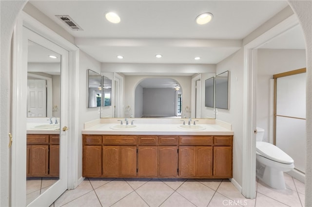 bathroom with tile patterned floors, vanity, and toilet