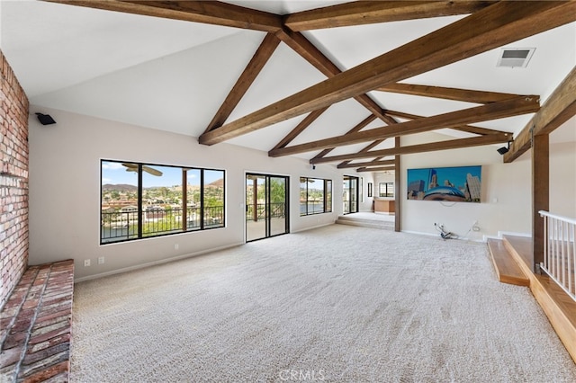 unfurnished living room featuring carpet floors, plenty of natural light, high vaulted ceiling, and beam ceiling