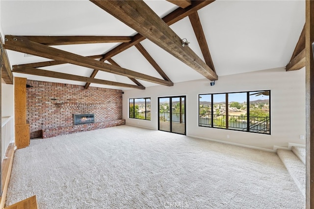 unfurnished living room featuring carpet flooring, beamed ceiling, high vaulted ceiling, and a brick fireplace