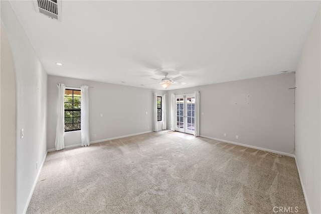 carpeted spare room with ceiling fan