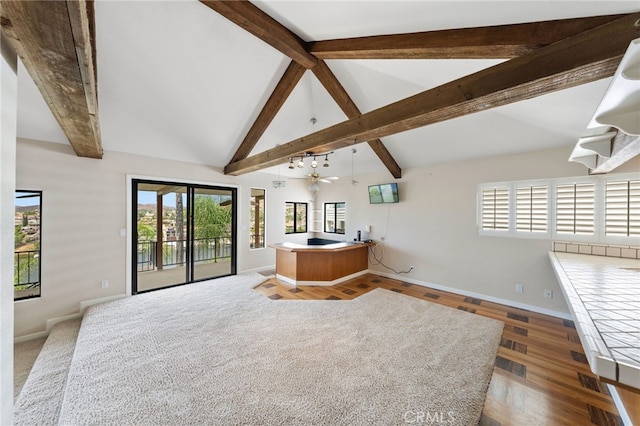 living room featuring beamed ceiling, ceiling fan, wood-type flooring, and high vaulted ceiling