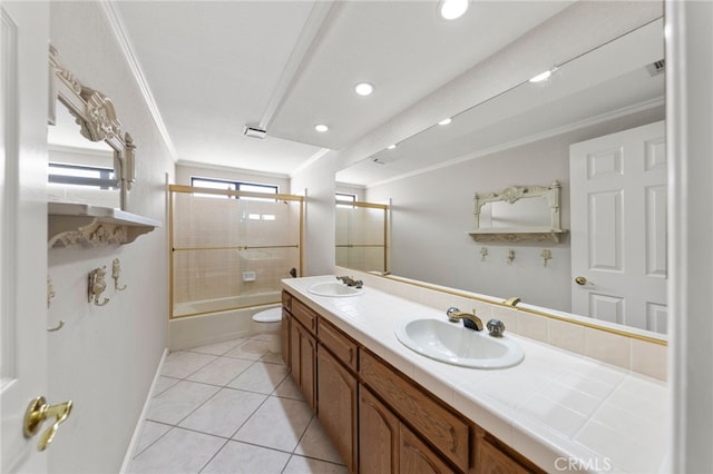 full bathroom featuring tile patterned flooring, combined bath / shower with glass door, crown molding, toilet, and vanity