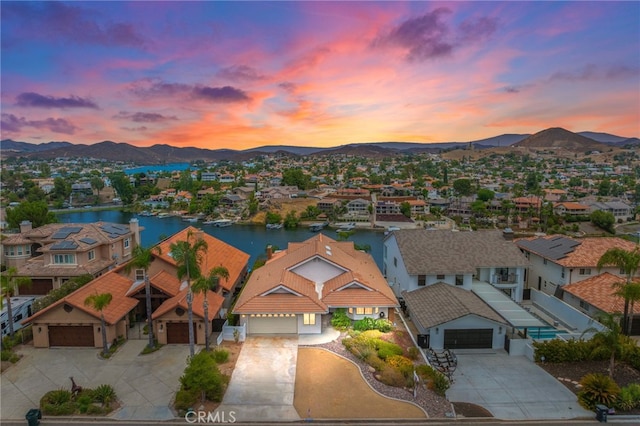 aerial view at dusk with a water and mountain view