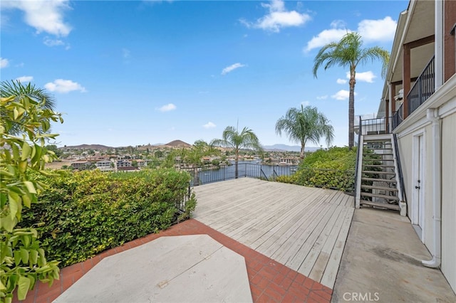 view of patio with a deck with water view