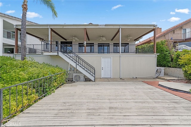 rear view of property featuring ceiling fan, a deck, and ac unit