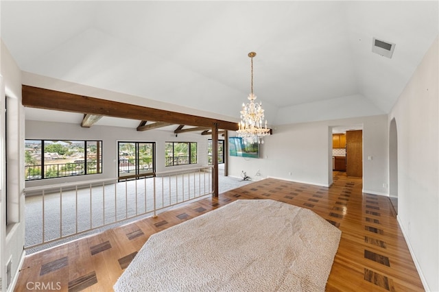 dining area with vaulted ceiling with beams, an inviting chandelier, and hardwood / wood-style flooring