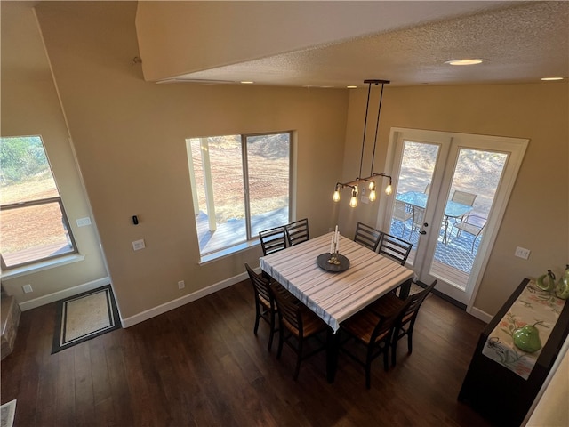 dining space with lofted ceiling, a textured ceiling, french doors, and dark hardwood / wood-style flooring