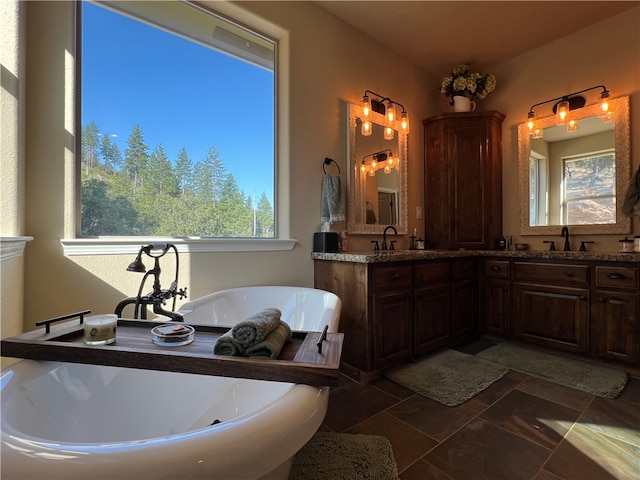 bathroom with vanity, a bath, and tile patterned flooring