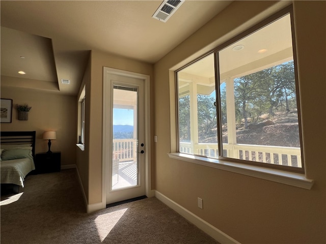 doorway to outside featuring carpet flooring