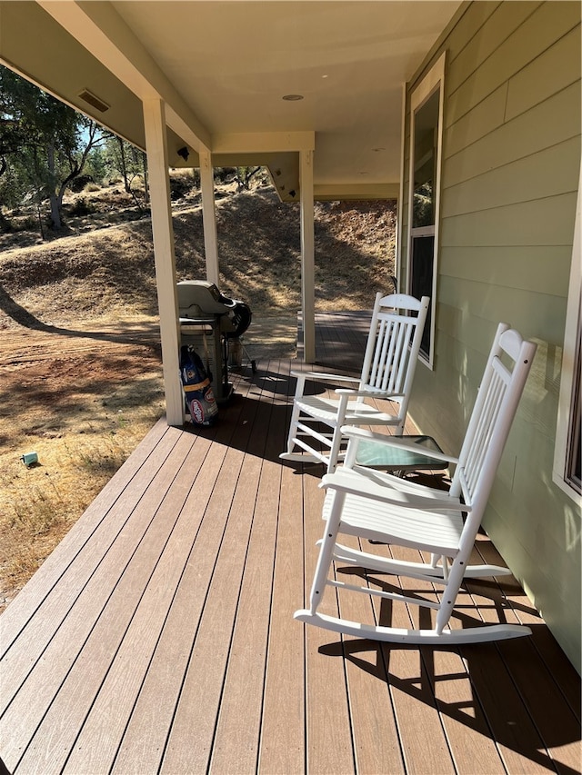 wooden terrace featuring a grill