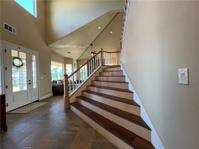 foyer entrance featuring a towering ceiling