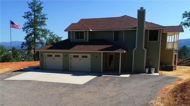 view of front of home featuring a mountain view, a balcony, and a garage