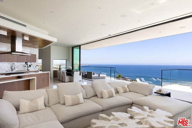 living room with sink and a water view